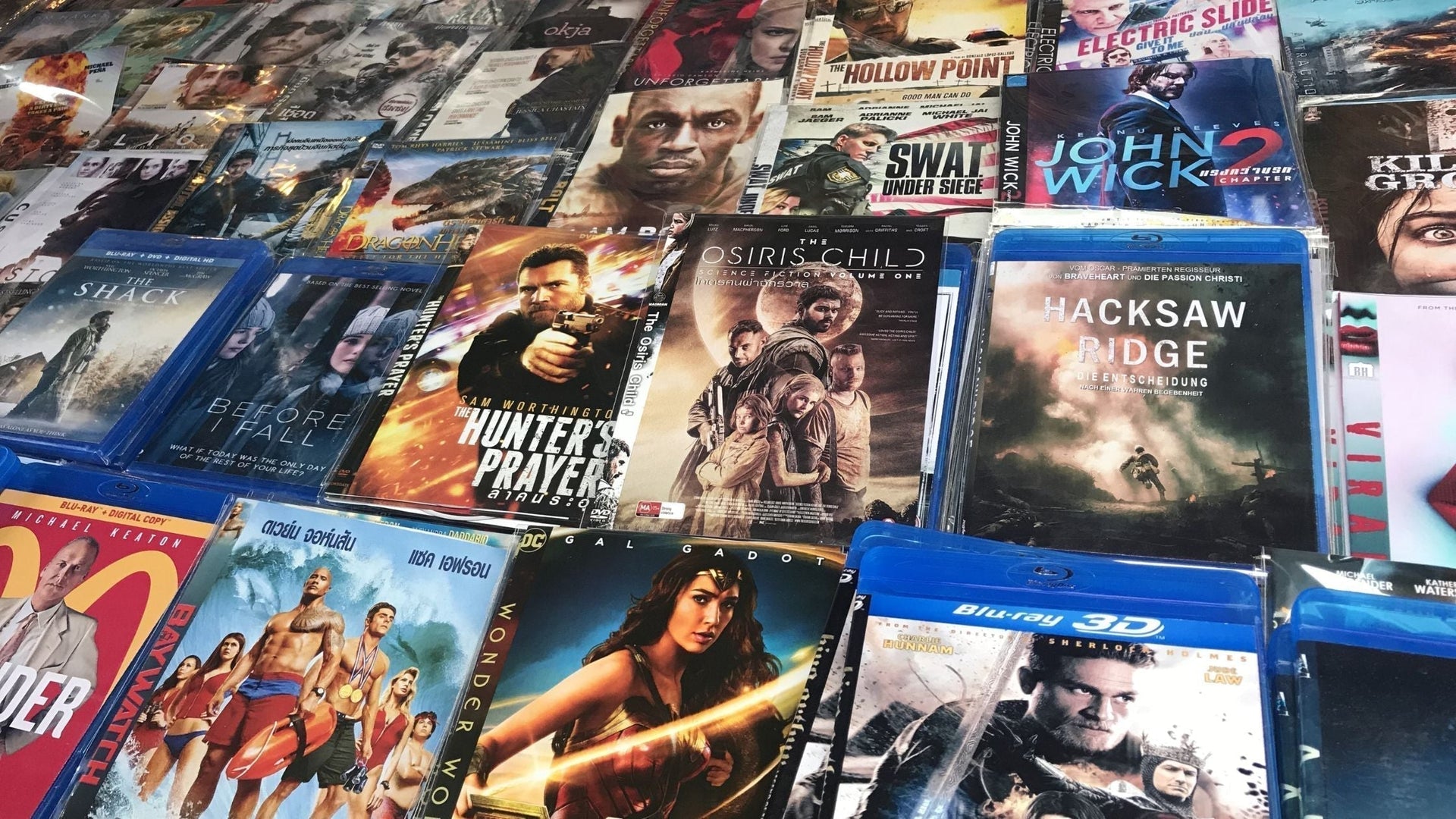 A visually appealing graphic featuring the title '50 Must-Watch Movies' with a background of various iconic movie scenes and film reels, promoting perfect picks for DVD, Blu-ray, and 4K collections.